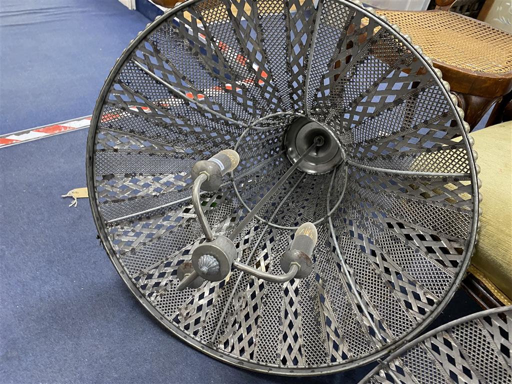 A large pierced metal ceiling shade